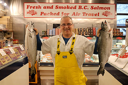 Granville Island Longliner Seafoods Ltd. business owner Scott Moorehead holds up Pacific Chinook salmon for sale.